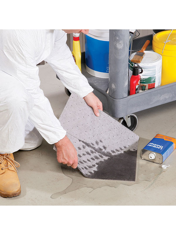Spill clean up with a gray absorbent spill pad